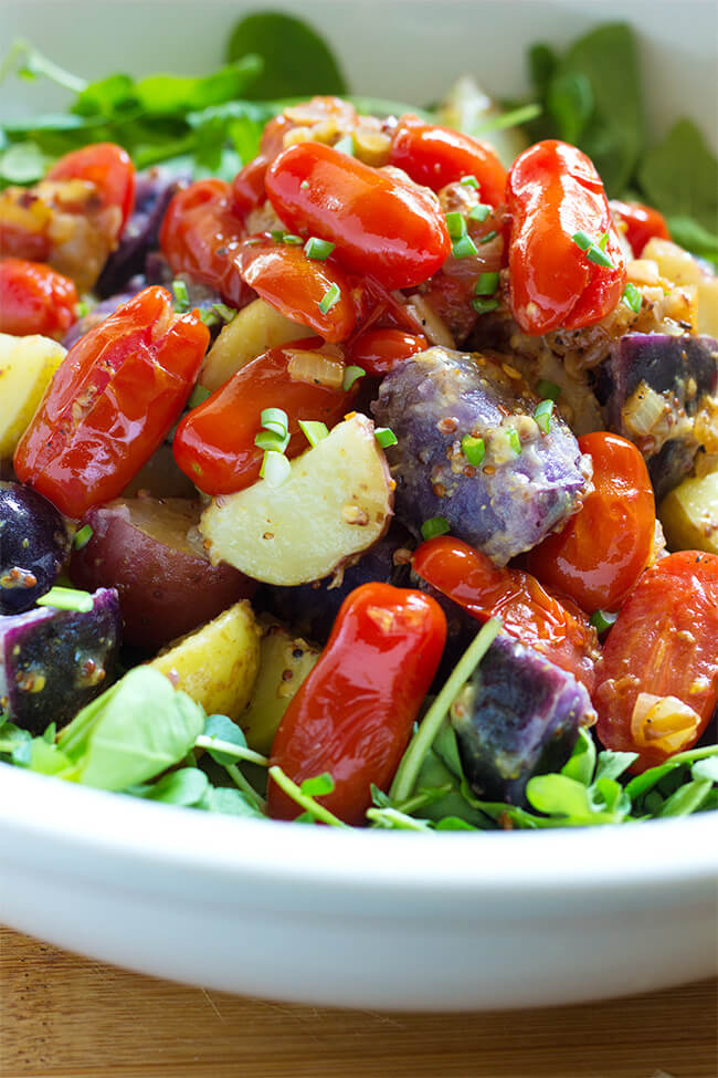 Warm tomato and potato salad is one of my favorite salads of all time. Vegetables are generously tossed in a mustard vinaigrette and served over a mix salad.