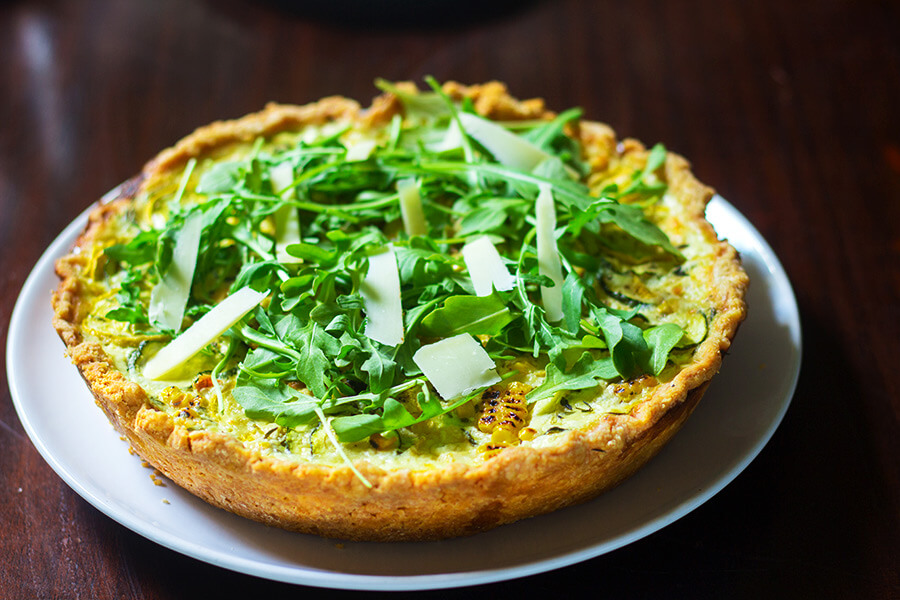 This summer squash roasted corn tart has thinly sliced yellow summer squash, zucchini, and roasted corn are tossed in shallots, thyme, goat cheese and garlic then topped with Gruyere cheese- I don't see how that can be any kind of bad.