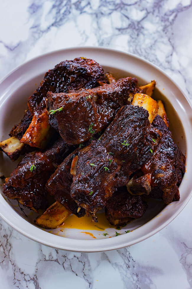 These easy oven baked jerk beef ribs are seasoned to the bone, slow braised, tender and juicy. These ribs will be a hit- fall off the bone perfection!