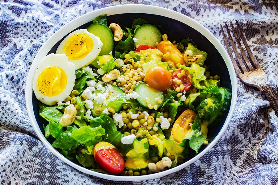 This Summer Harvest Sorghum Salad recipe has sweet ripe tomatoes, crisp lettuce creamy goat cheese & toasted cashews covered in creamy curry dressing.
